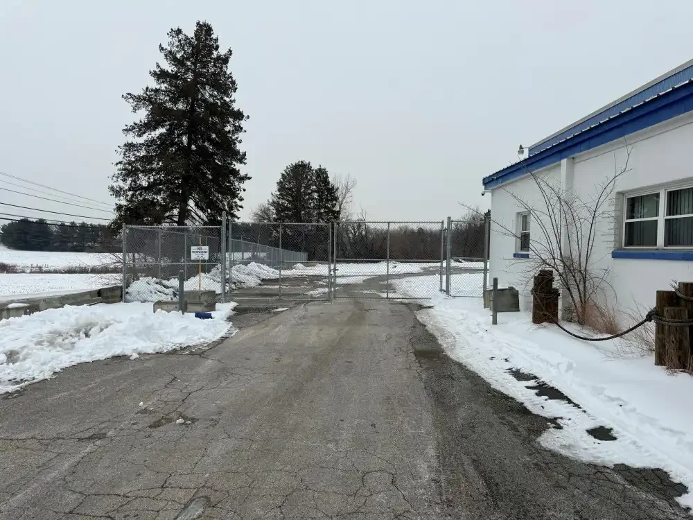 Secure fenced entrance at truck parking facility in York, PA with gated access.